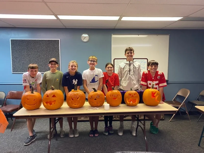 Youth carving pumpkins